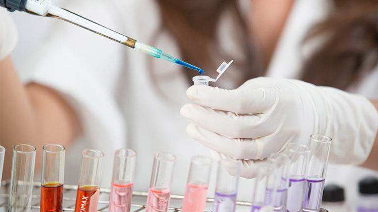 Lab technician holding test tubes